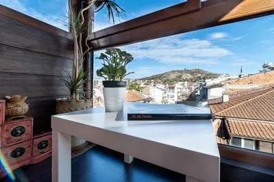 a white table on a balcony with a view at Penthouse Tepeto in Plovdiv