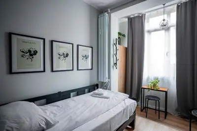 a bedroom with a bed and a window at Tom Thumb & Thumbelina - 2 Private Rooms in Sofia Center by Flat Mаnager in Sofia
