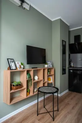 a living room with a table and a tv at Tom Thumb & Thumbelina - 2 Private Rooms in Sofia Center by Flat Mаnager in Sofia