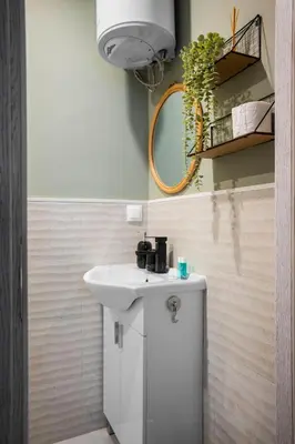 a bathroom with a white sink and a mirror at Tom Thumb & Thumbelina - 2 Private Rooms in Sofia Center by Flat Mаnager in Sofia