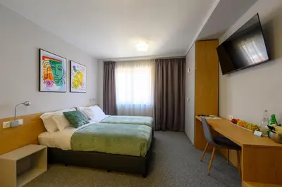 a hotel room with a bed and a desk at LOCATION in Sofia