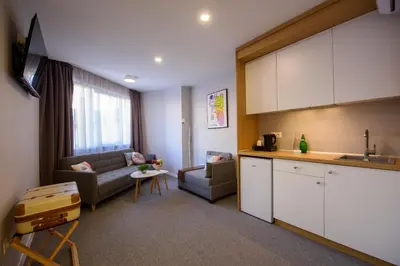 a kitchen and a living room with a couch at LOCATION in Sofia