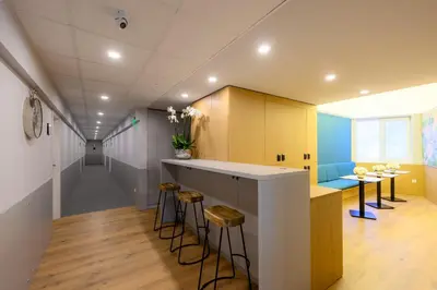 a kitchen with a counter and stools in a room at LOCATION in Sofia