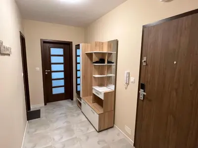 a hallway with a door and a sink in a room at Апартамент Комфорт 2 Близо до Летището in Sofia