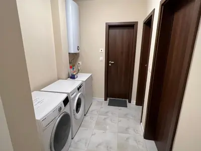 a laundry room with a washer and dryer at Апартамент Комфорт 2 Близо до Летището in Sofia