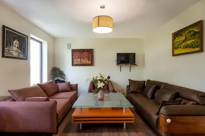 a living room with a couch and a table at ВИЛА МАРИНОВИ in Boykovo