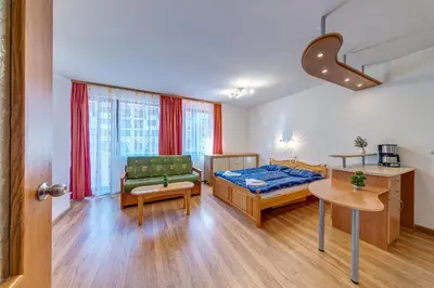 a bedroom with a bed and a couch and a table at Cozy Studio in Hotel Laplandia, Pamporovo by Flat Mаnager in Pamporovo