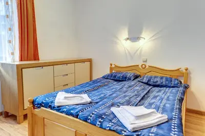 a bedroom with a blue bed with towels on it at Cozy Studio in Hotel Laplandia, Pamporovo by Flat Mаnager in Pamporovo