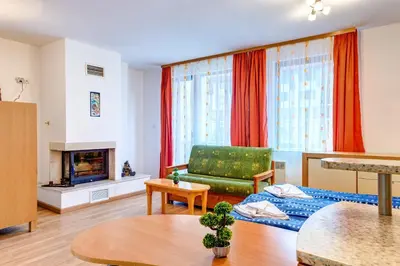 a living room with a couch and a table at Cozy Studio in Hotel Laplandia, Pamporovo by Flat Mаnager in Pamporovo