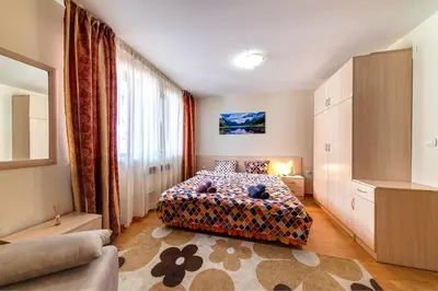 a bedroom with a bed and a large window at 1BD Ski View Retreat in Pamporovo with Fireplace by Flat Mаnager in Pamporovo