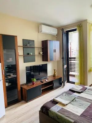 a room with a bed and a television in a room at Studio El - All seasons in Bansko