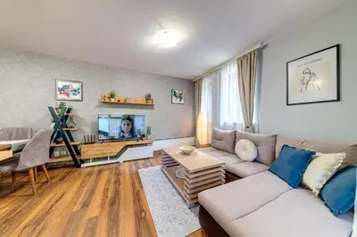 a living room with a couch and a tv at Luxury Flat in Grand Resort Pamporovo by Flat Mаnager in Pamporovo