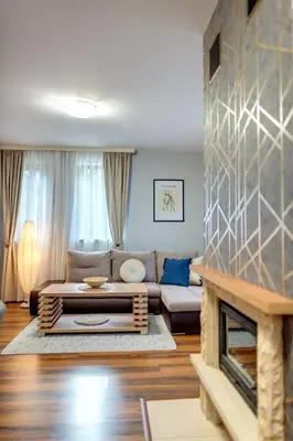 a living room with a couch and a fireplace at Luxury Flat in Grand Resort Pamporovo by Flat Mаnager in Pamporovo