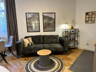 a living room with a couch and a table at Sana Ski apartment 313A in Flora, Borovets in Borovets