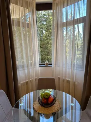 a bowl of fruit on a glass table in front of a window at Sana Ski apartment 313A in Flora, Borovets in Borovets