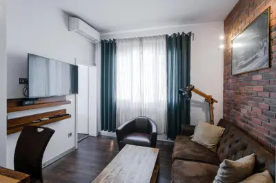 a living room with a couch and a table at Designer 1BD Cinématique on Solunska by Flat Mаnager in Sofia