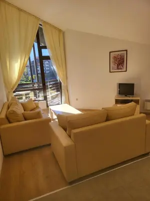 a living room with two couches and a television at Aspen Golf D 401 in Bansko