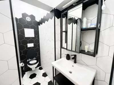 a black and white bathroom with a sink and a toilet at Perfect Long-term Stay Stylish and Spacious Top Center Next to Vitosha Blvd in Sofia