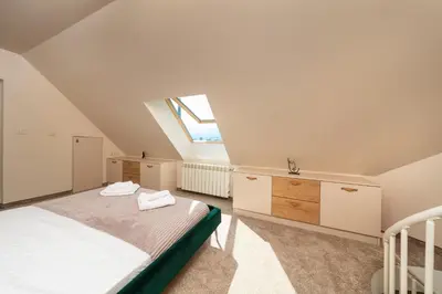 a attic bedroom with a bed and a window at Modern Maisonette - 2 Bedrooms - Terrace - Vitosha View in Sofia