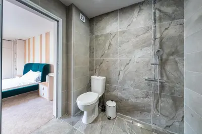 a bathroom with a toilet and a shower at Modern Maisonette - 2 Bedrooms - Terrace - Vitosha View in Sofia