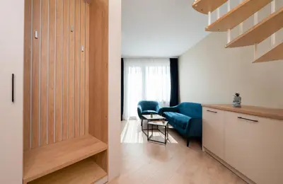 a room with a door and a chair and a table at Modern Maisonette - 2 Bedrooms - Terrace - Vitosha View in Sofia