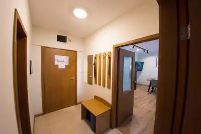 a hallway with a door and a room with surfboards on the wall at Antonovi Apartments Deluxe in hotel Laplandia in Pamporovo