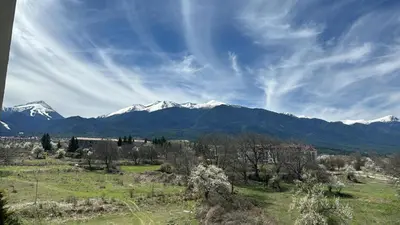 a view of a mountain range with snow covered mountains at Alpine Lodge Bansko Apartments in Bansko