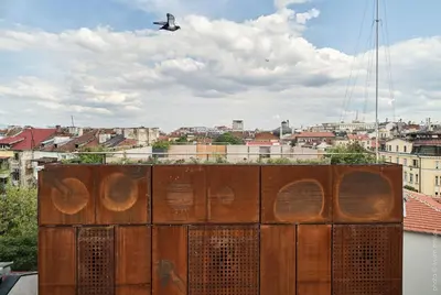 a plane flying in the sky over a city at DOT Sofia in Sofia