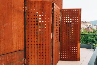 a wooden fence with holes in it on a balcony at DOT Sofia in Sofia