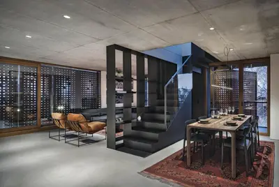 a dining room with a table and chairs and windows at DOT Sofia in Sofia