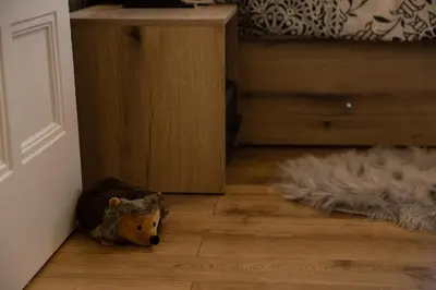 a teddy bear laying on the floor of a room at Apartment Serdika 1 in Sofia