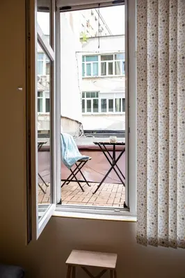 a window with a view of a balcony with a table at Apartment Serdika 1 in Sofia