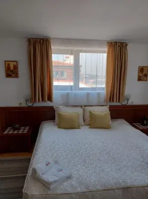 a bedroom with a large bed with a window at Gondola lift apartment 5401 in Bansko