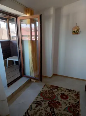 a room with a glass door and a rug at Gondola lift apartment 5401 in Bansko