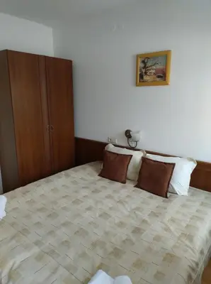 a bedroom with a large bed with brown pillows at Gondola lift apartment 5402 in Bansko