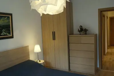 a bedroom with a bed and a cabinet and a lamp at 