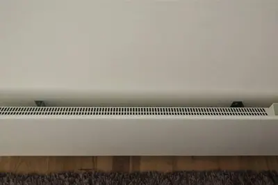 a white wall with a white floor and a white shelf at 