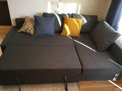 a gray couch with pillows on it in a living room at 