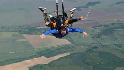 a man flying through the air on a parachute at Guesthouse The Rock in Sapareva Banya