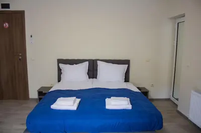 a blue bed with towels on top of it at Guesthouse The Rock in Sapareva Banya