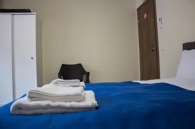 a pile of towels sitting on top of a bed at Guesthouse The Rock in Sapareva Banya