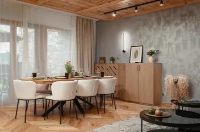 a dining room with a table and white chairs at Luxury Villa with Hot Pool in Banya