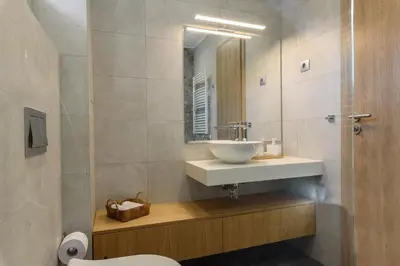 a bathroom with a sink and a mirror at Luxury Villa with Hot Pool in Banya