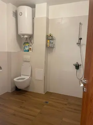 a bathroom with a toilet and a water tank at апартамент Римската стена in Hisarya