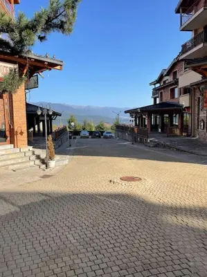 a cobblestone street in a town with buildings at Pirin Golf Mountain View Retreat in Razlog