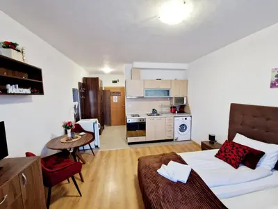 a living room with a bed and a kitchen at Studio Maria in Bansko