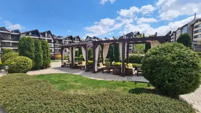 a gazebo in a park with bushes and trees at Studio Maria in Bansko