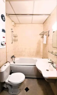 a bathroom with a tub and a toilet and a sink at Studio Maria in Bansko