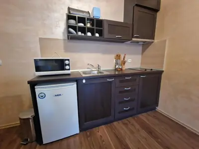 a small kitchen with a sink and a microwave at Bansko Royal Towers George Apartment, next to the Gongola in Bansko