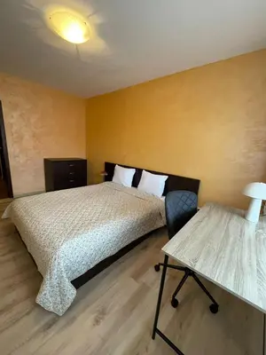 a bedroom with a large bed and a desk at Bansko Royal Towers George Apartment, next to the Gongola in Bansko